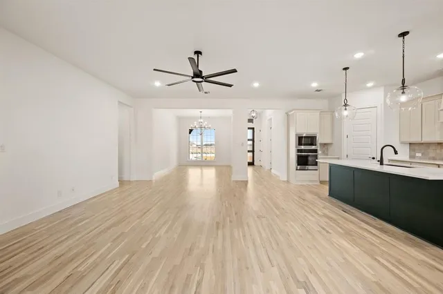 a view of a kitchen with a sink and wooden floor