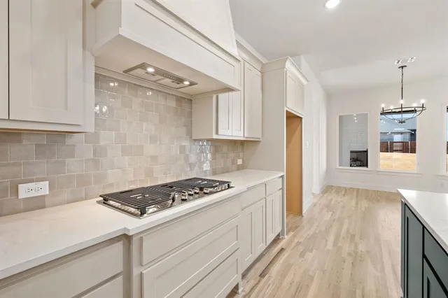 a kitchen with granite countertop a stove and a refrigerator