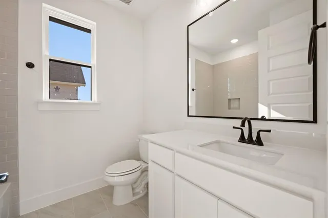a bathroom with a toilet a sink and mirror