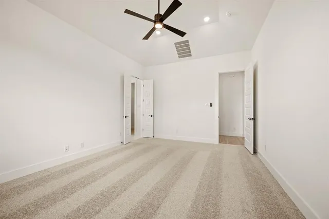 a view of a livingroom with a ceiling fan and window