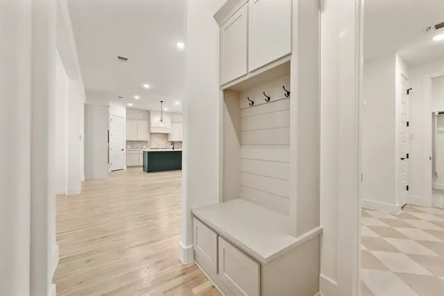 an empty room with a window and a ceiling fan