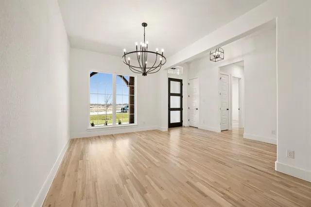 a view of a room with wooden floor and window