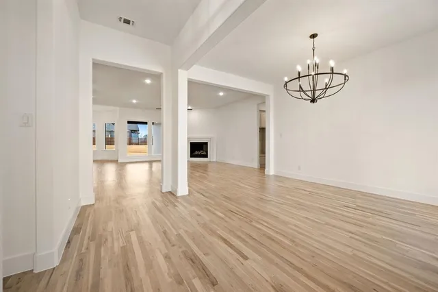 a view of a room with wooden floor and white walls