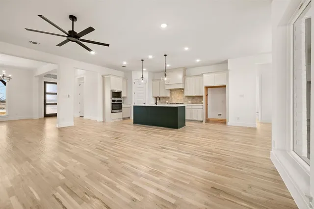 a view of a kitchen with a sink and a refrigerator