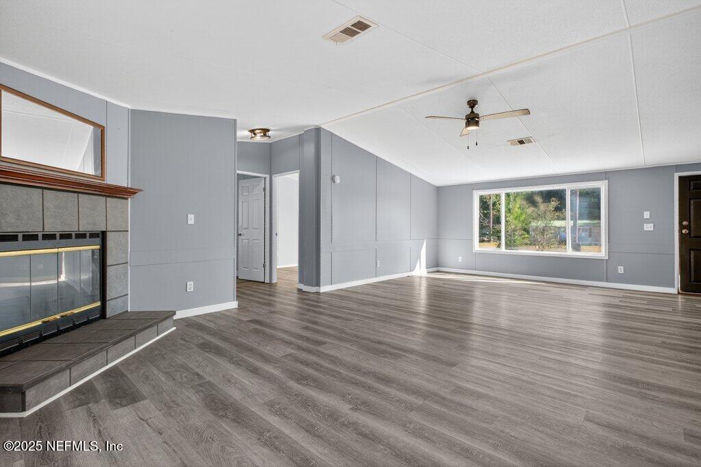 9899 Barber Loop Macclenny, FL 32063 - Photo 12 of 43 a view of an empty room with a window and wooden floor
