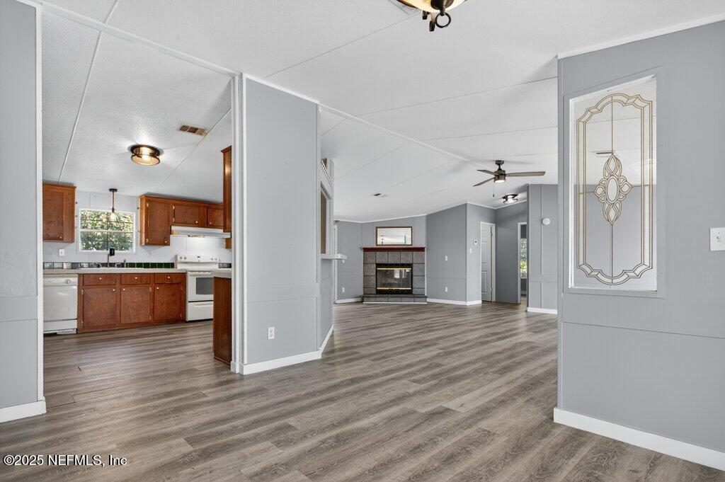 9899 Barber Loop Macclenny, FL 32063 - Photo 14 of 43 a view of a kitchen with a refrigerator and a stove top oven