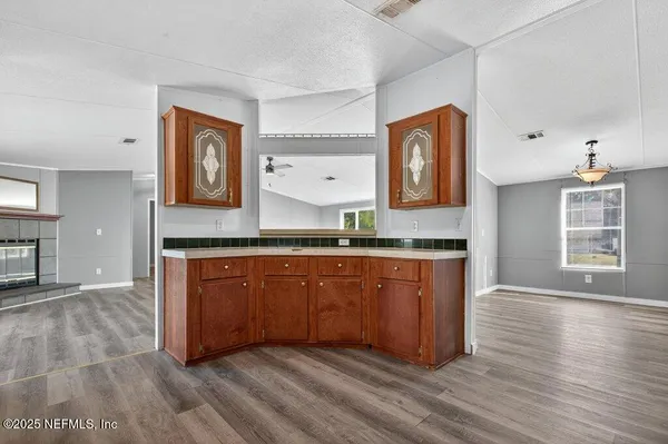 a spacious bathroom with stainless steel appliances granite countertop a sink and a large mirror