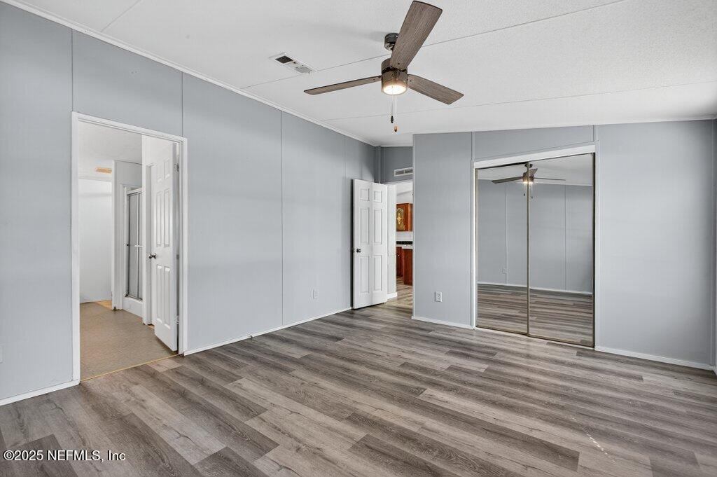 9899 Barber Loop Macclenny, FL 32063 - Photo 25 of 43 a view of empty room with wooden floor