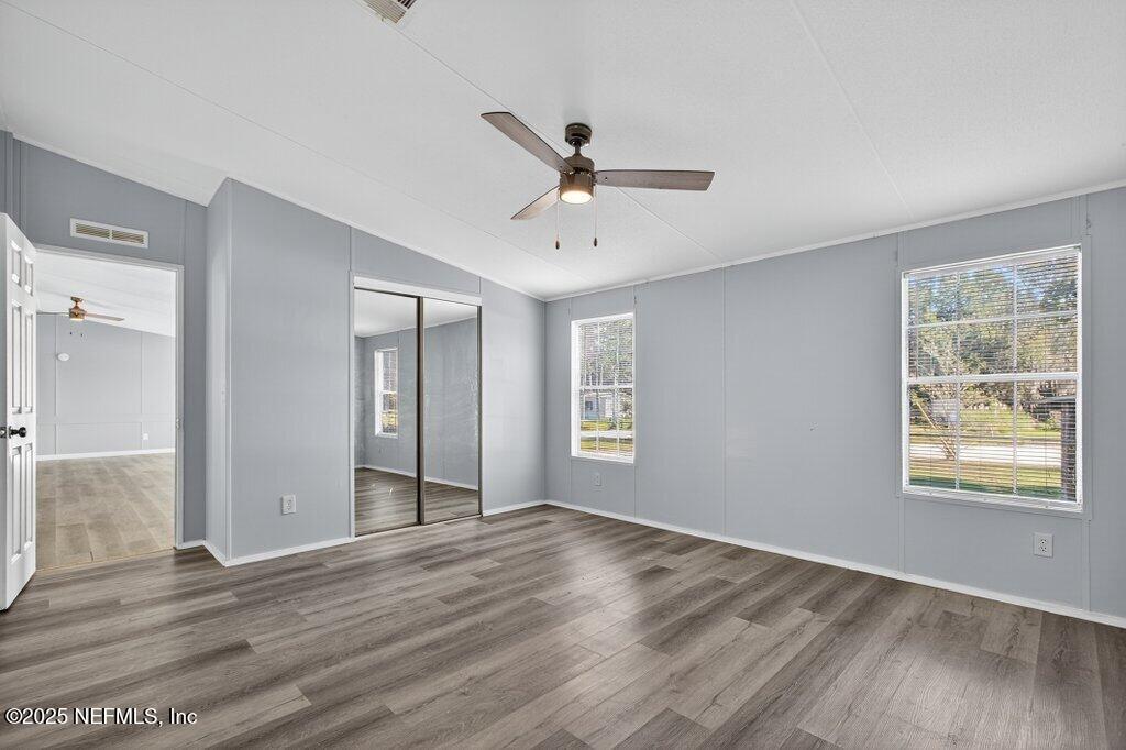9899 Barber Loop Macclenny, FL 32063 - Photo 26 of 43 a view of an empty room with wooden floor and a window