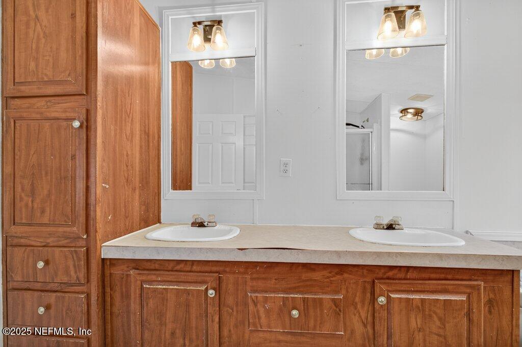 9899 Barber Loop Macclenny, FL 32063 - Photo 29 of 43 a bathroom with a granite countertop sink and a mirror
