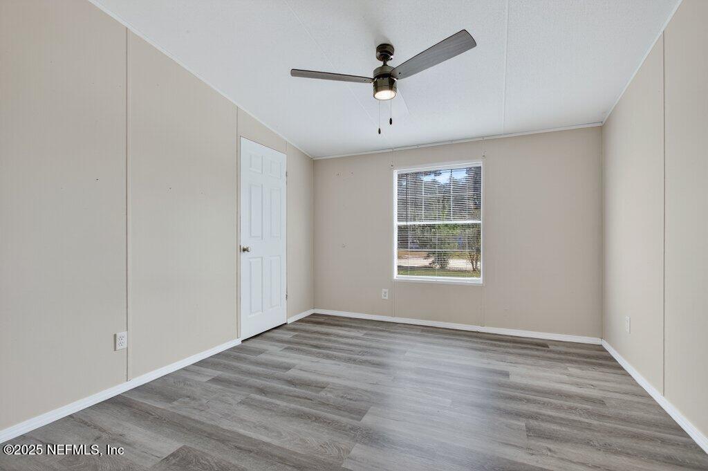 9899 Barber Loop Macclenny, FL 32063 - Photo 31 of 43 a view of a big room with wooden floor and windows