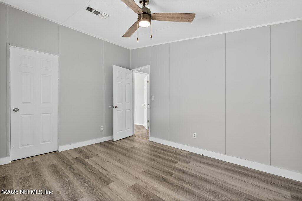 9899 Barber Loop Macclenny, FL 32063 - Photo 34 of 43 a view of an empty room with wooden floor