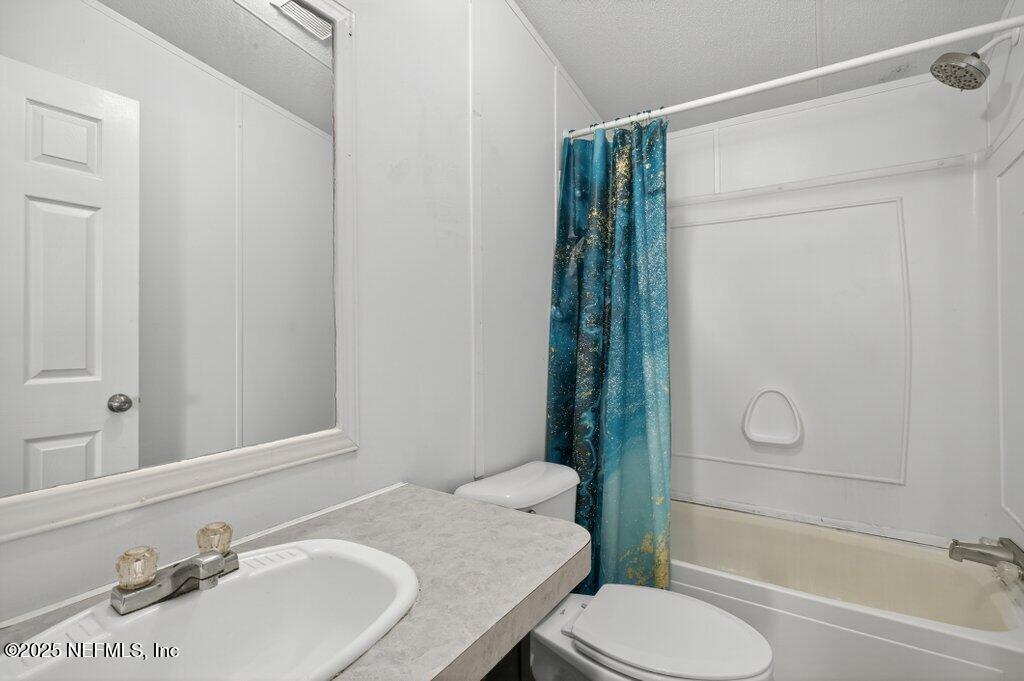 9899 Barber Loop Macclenny, FL 32063 - Photo 35 of 43 a bathroom with a sink toilet and shower