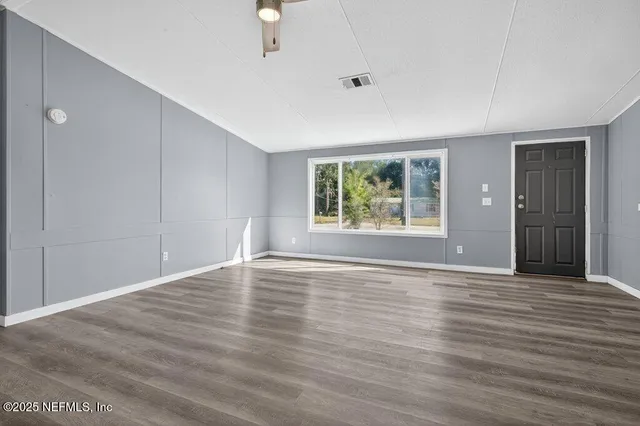 wooden floor in an empty room with a window