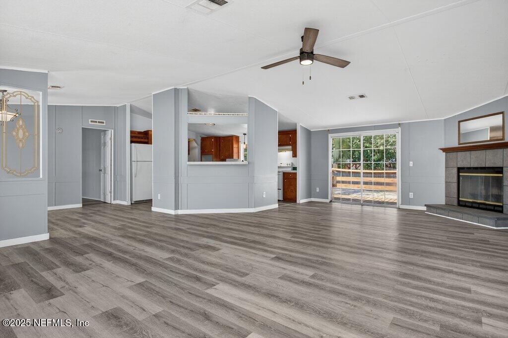 9899 Barber Loop Macclenny, FL 32063 - Photo 9 of 43 a view of empty room with wooden floor and fireplace