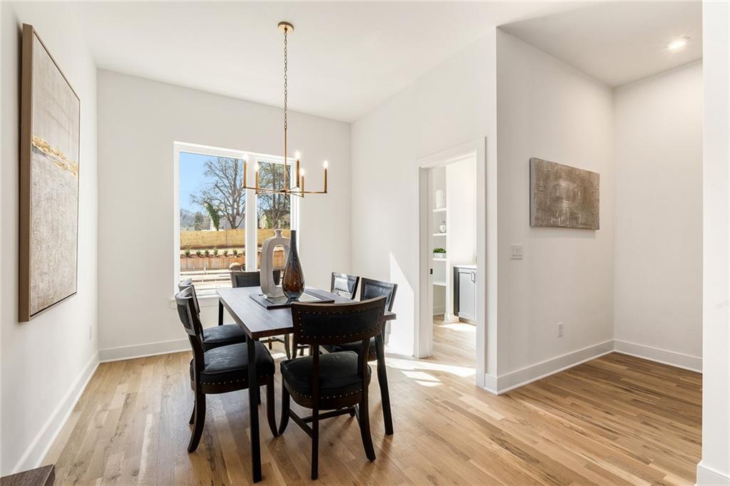 1237 Memorial Drive Southeast, Unit 403 Atlanta, GA 30316 - Photo 13 of 38 a view of a dining room with furniture window and wooden floor