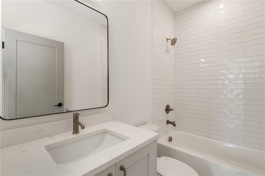 1237 Memorial Drive Southeast, Unit 403 Atlanta, GA 30316 - Photo 22 of 38 a bathroom with a sink toilet and shower