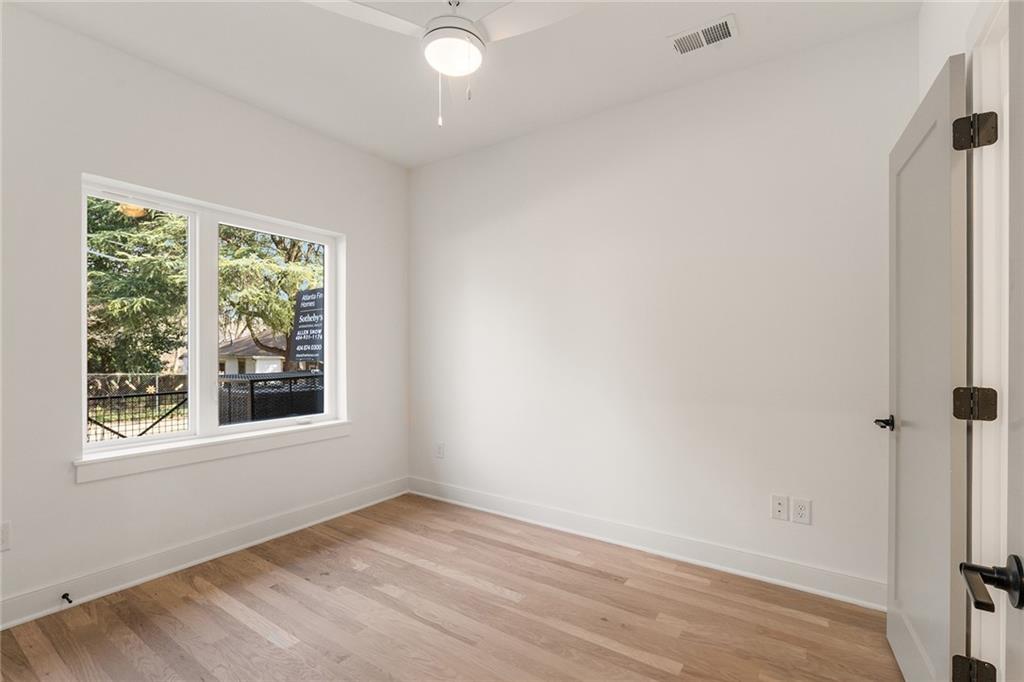1237 Memorial Drive Southeast, Unit 403 Atlanta, GA 30316 - Photo 26 of 38 an empty room with wooden floor and windows