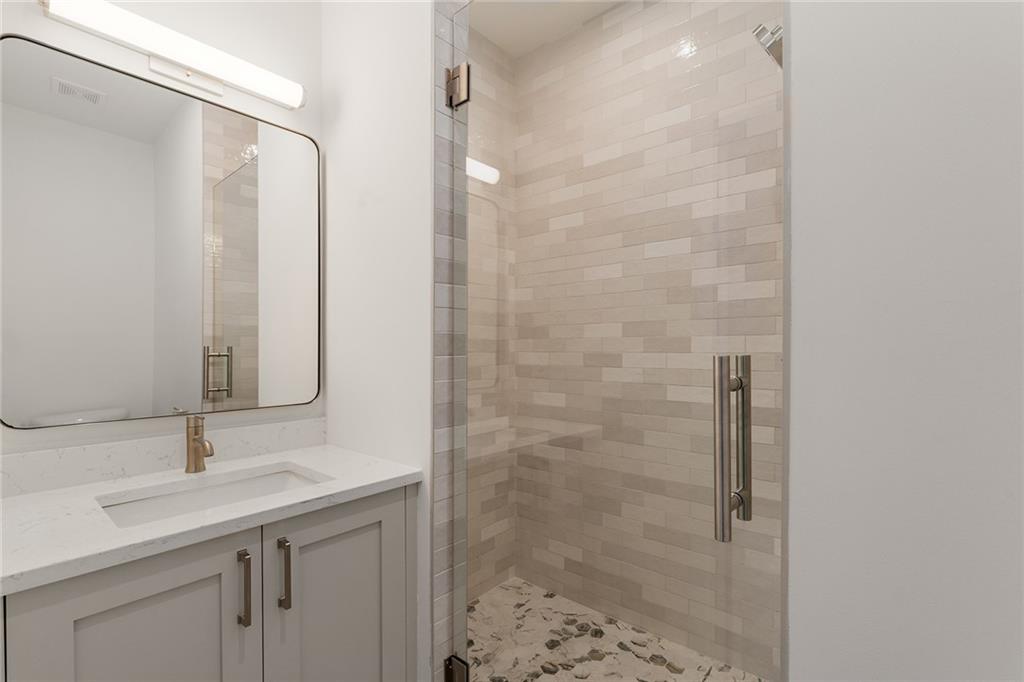 1237 Memorial Drive Southeast, Unit 403 Atlanta, GA 30316 - Photo 28 of 38 a bathroom with a sink and a mirror