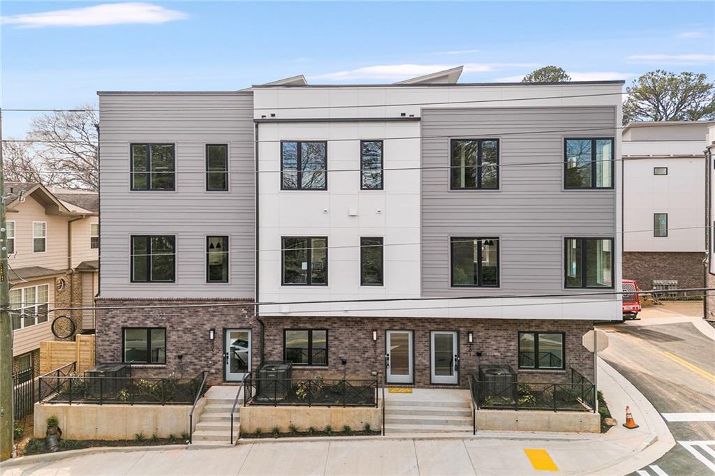 1237 Memorial Drive Southeast, Unit 403 Atlanta, GA 30316 - Photo 32 of 38 a front view of a building with many windows