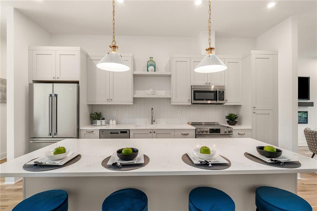 1237 Memorial Drive Southeast, Unit 403 Atlanta, GA 30316 - Photo 9 of 38 a kitchen with white cabinets and sink