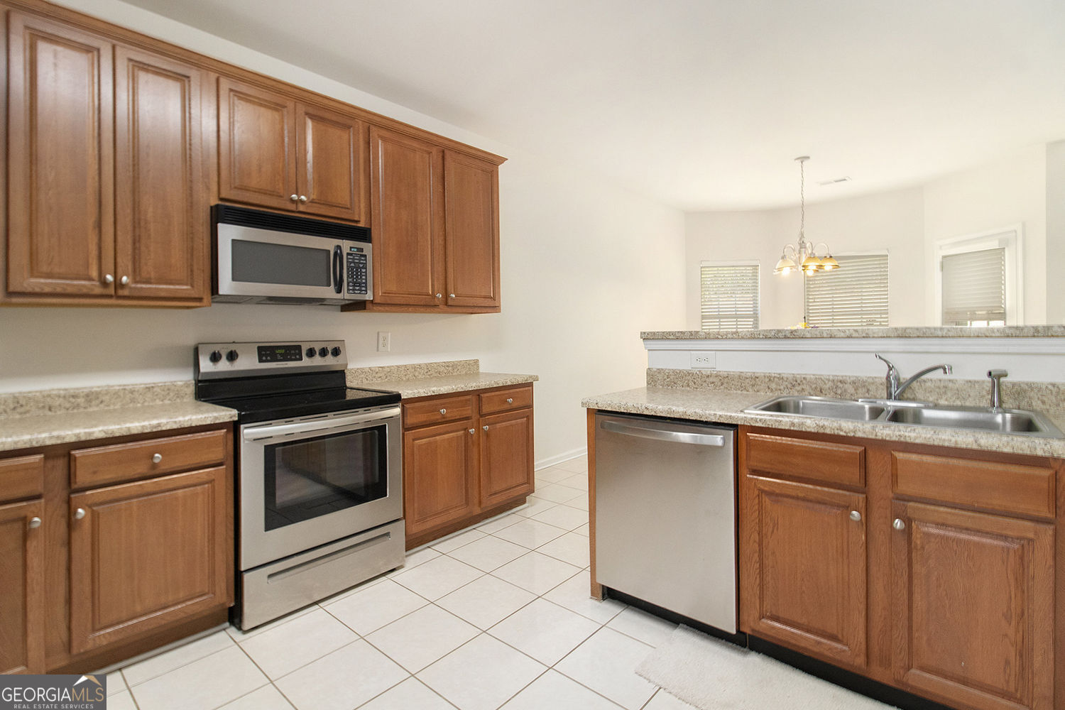 48 Garden View Terrace Newnan, GA 30263 - Photo 14 of 25 a kitchen with granite countertop cabinets stainless steel appliances and a sink