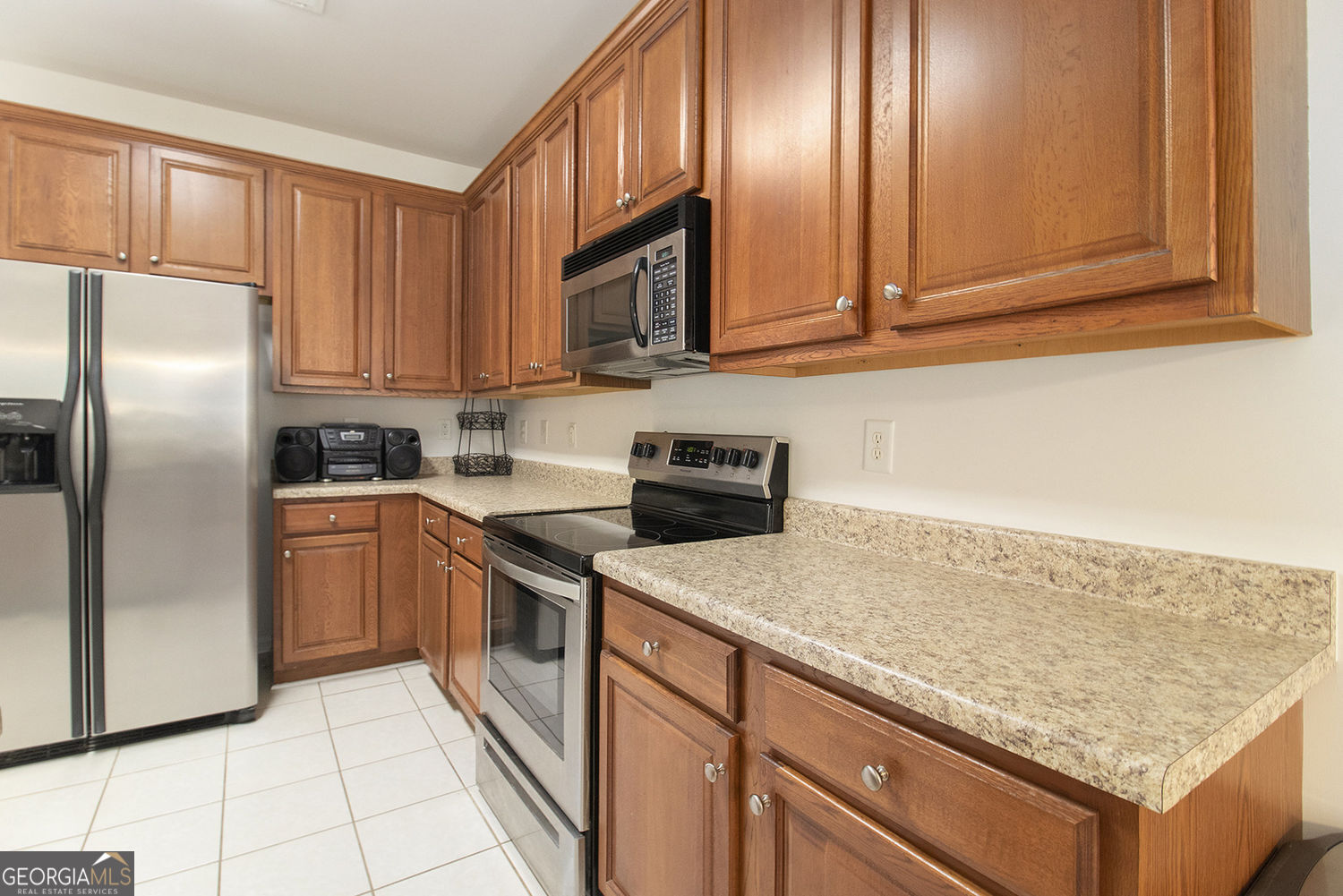 48 Garden View Terrace Newnan, GA 30263 - Photo 15 of 25 a kitchen with stainless steel appliances granite countertop a refrigerator sink and cabinets