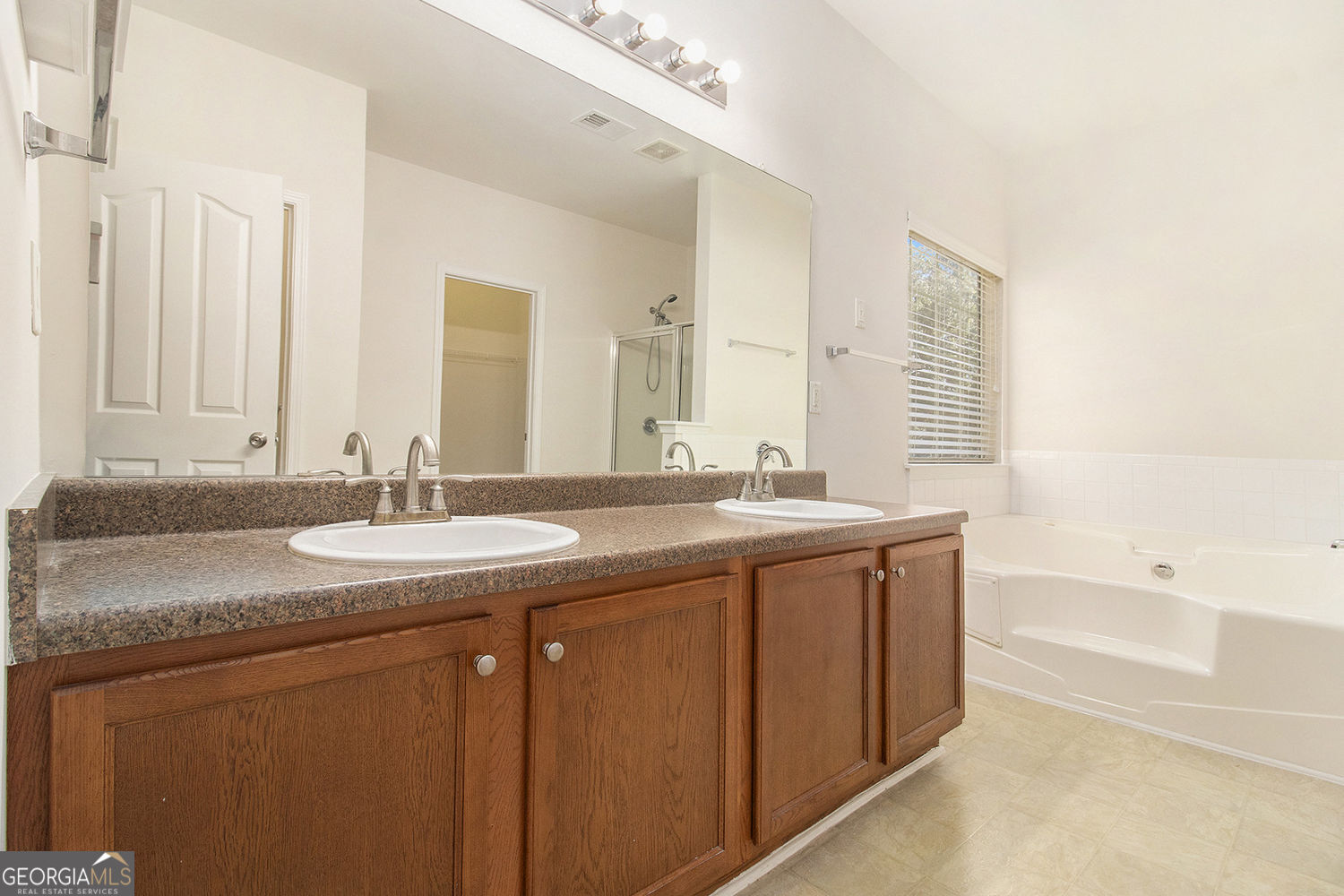 48 Garden View Terrace Newnan, GA 30263 - Photo 21 of 25 a bathroom with a granite countertop sink and a bathtub