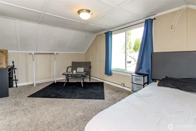 a bedroom with a bed and window