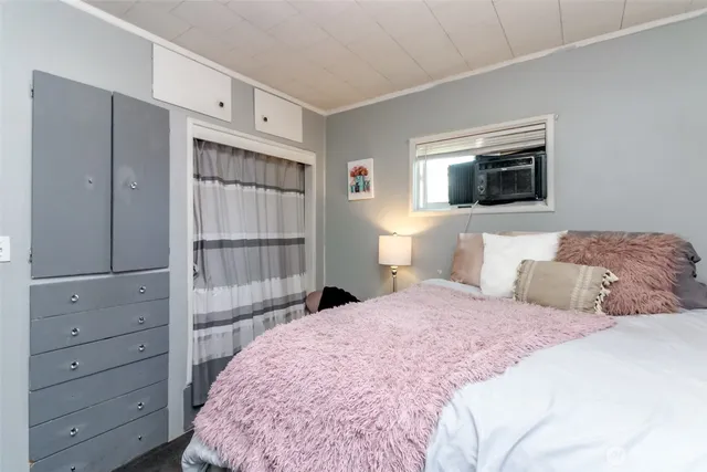 a bedroom with a bed and a television