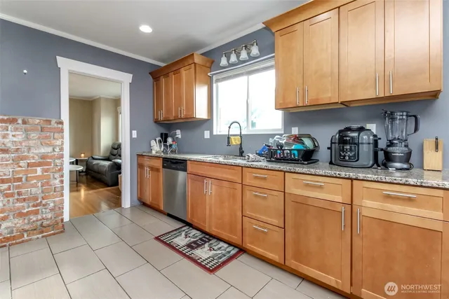 a kitchen with stainless steel appliances granite countertop a sink stove and cabinets