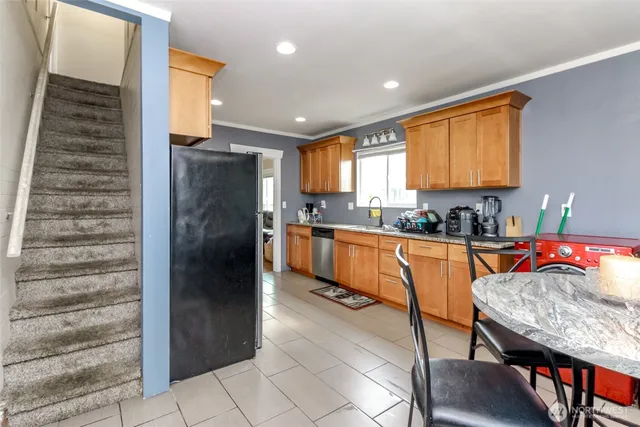 a kitchen with stainless steel appliances granite countertop a refrigerator and a stove