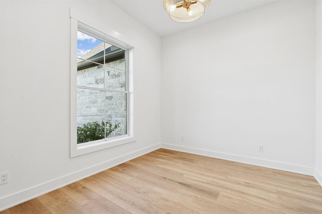 8008 Ben Day Murrin Road Fort Worth, TX 76126 - Photo 20 of 40 an empty room with wooden floor and window