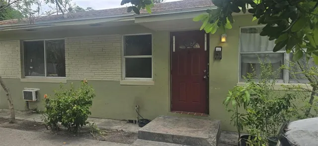 a potted plant in front of a house