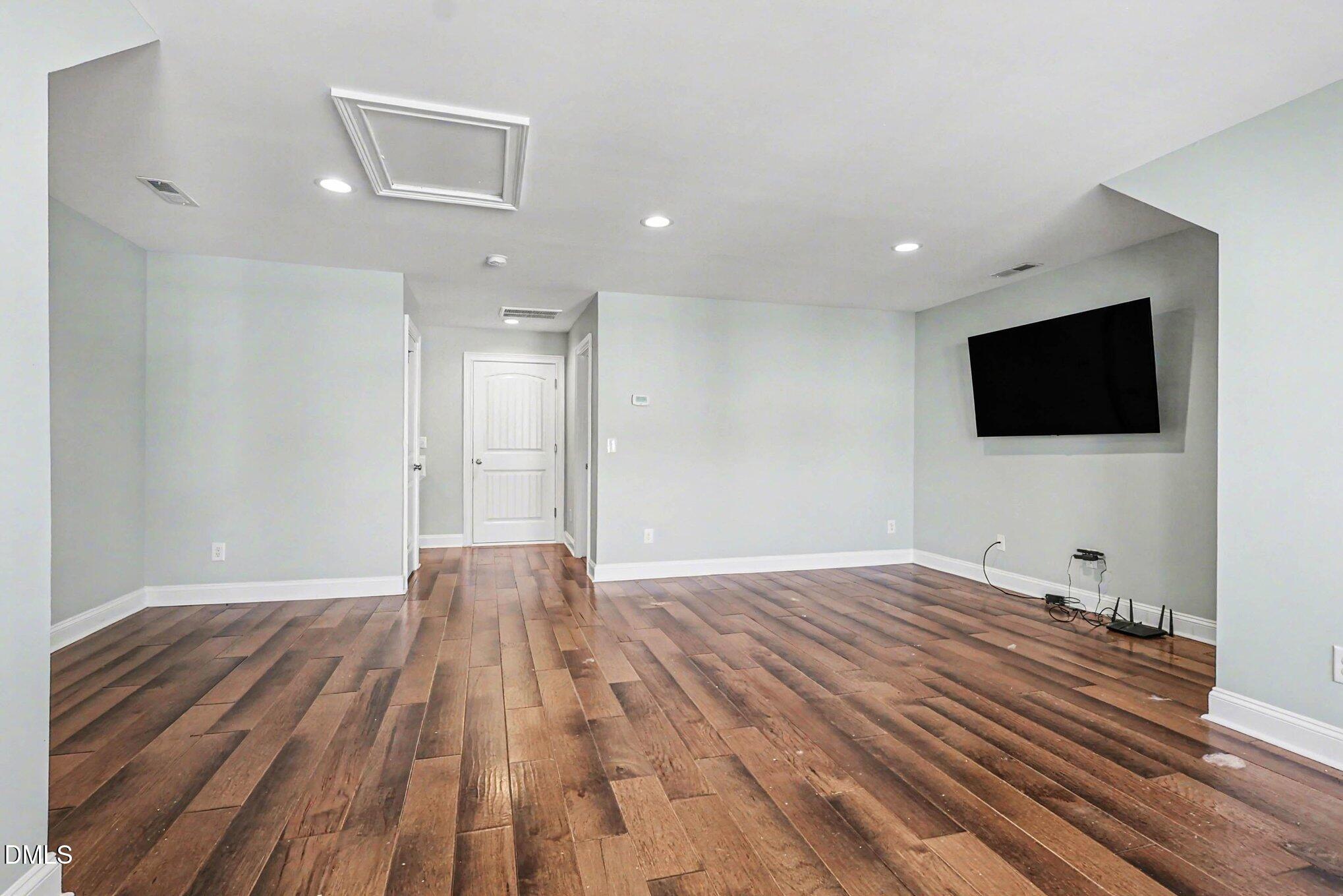 653 Fallon Grove Way Raleigh, NC 27608 - Photo 24 of 38 a view of a livingroom with a flat screen tv