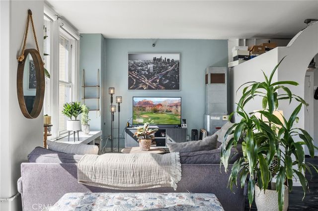 a living room with furniture a chandelier and a rug
