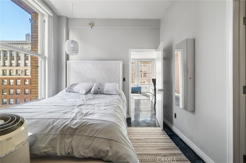215 West 7th Street, Unit 1008 Los Angeles, CA 90014 - Photo 19 of 39 a bedroom with a bed and wooden floor