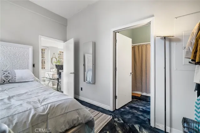 a bedroom with a bed and a mirror
