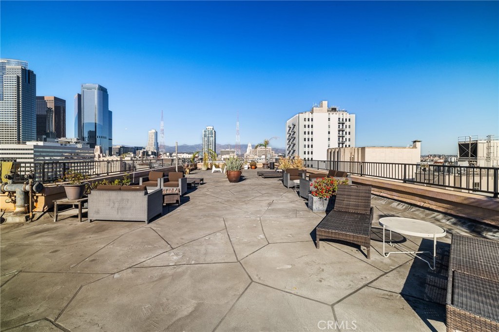 215 West 7th Street, Unit 1008 Los Angeles, CA 90014 - Photo 25 of 39 a roof deck with table and chairs a barbeque