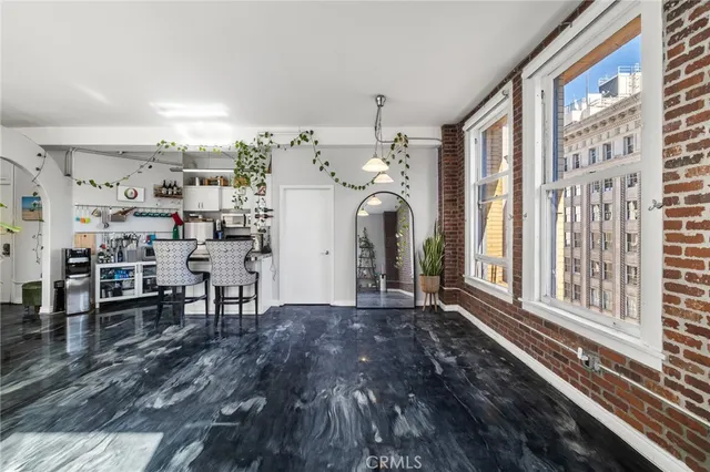 a view of a porch with furniture and floor to ceiling window