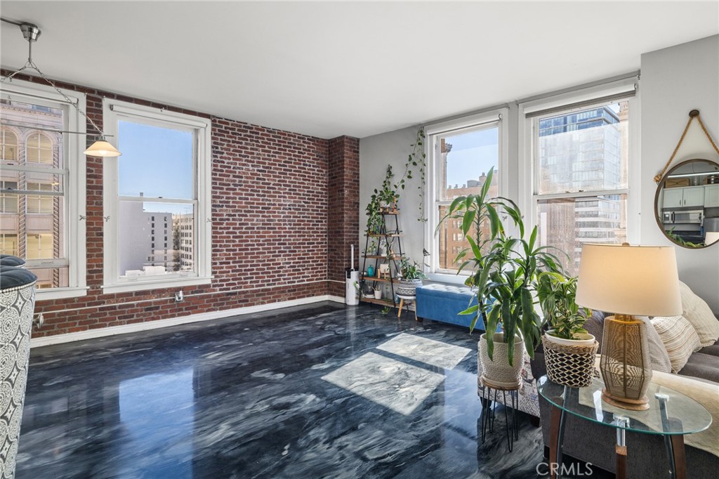 215 West 7th Street, Unit 1008 Los Angeles, CA 90014 - Photo 6 of 39 a living room with furniture and a large window