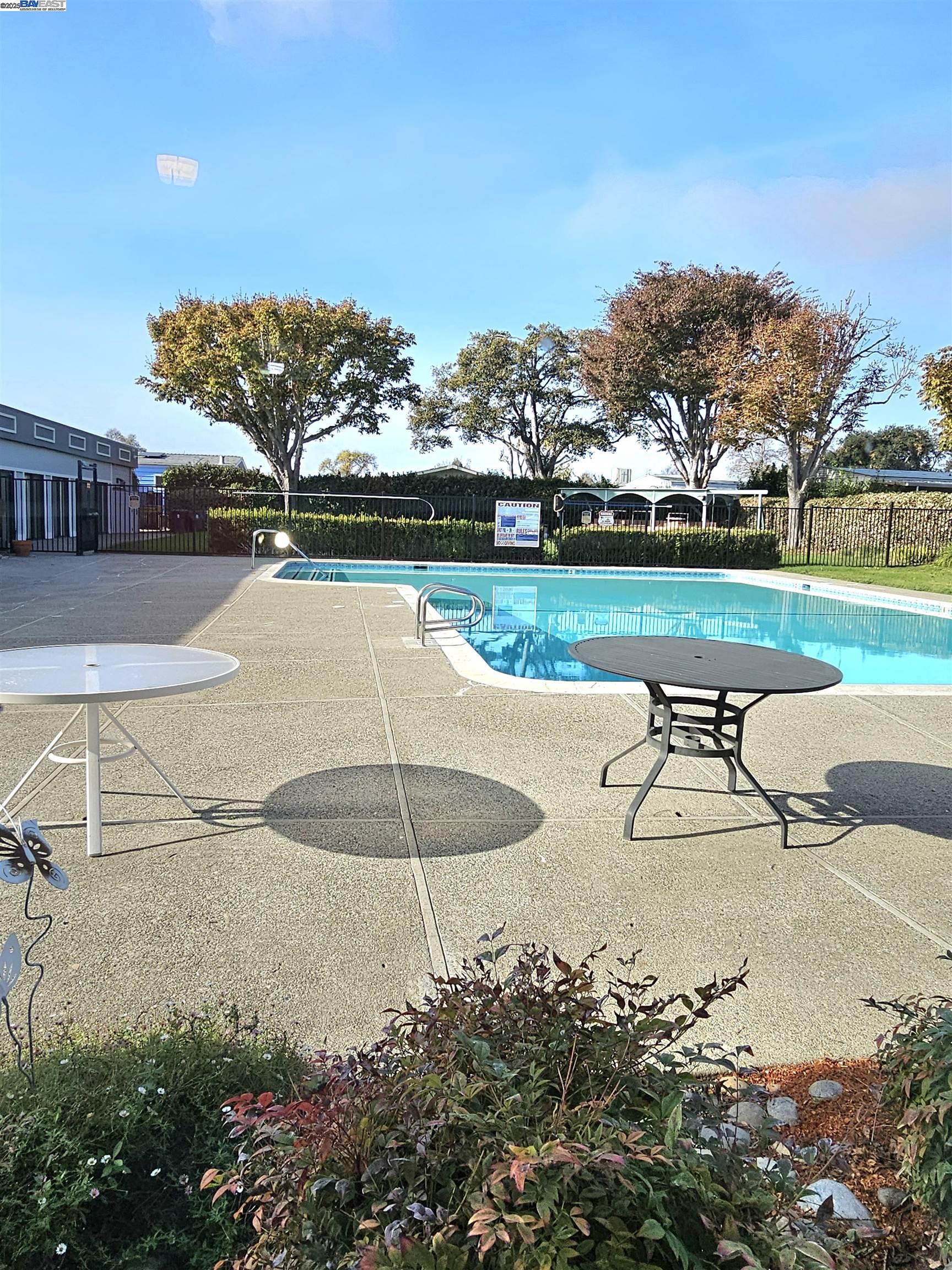4141 Deep Creek Road, Unit 106 Fremont, CA 94555 - Photo 35 of 37 a view of a swimming pool with a yard and sitting area