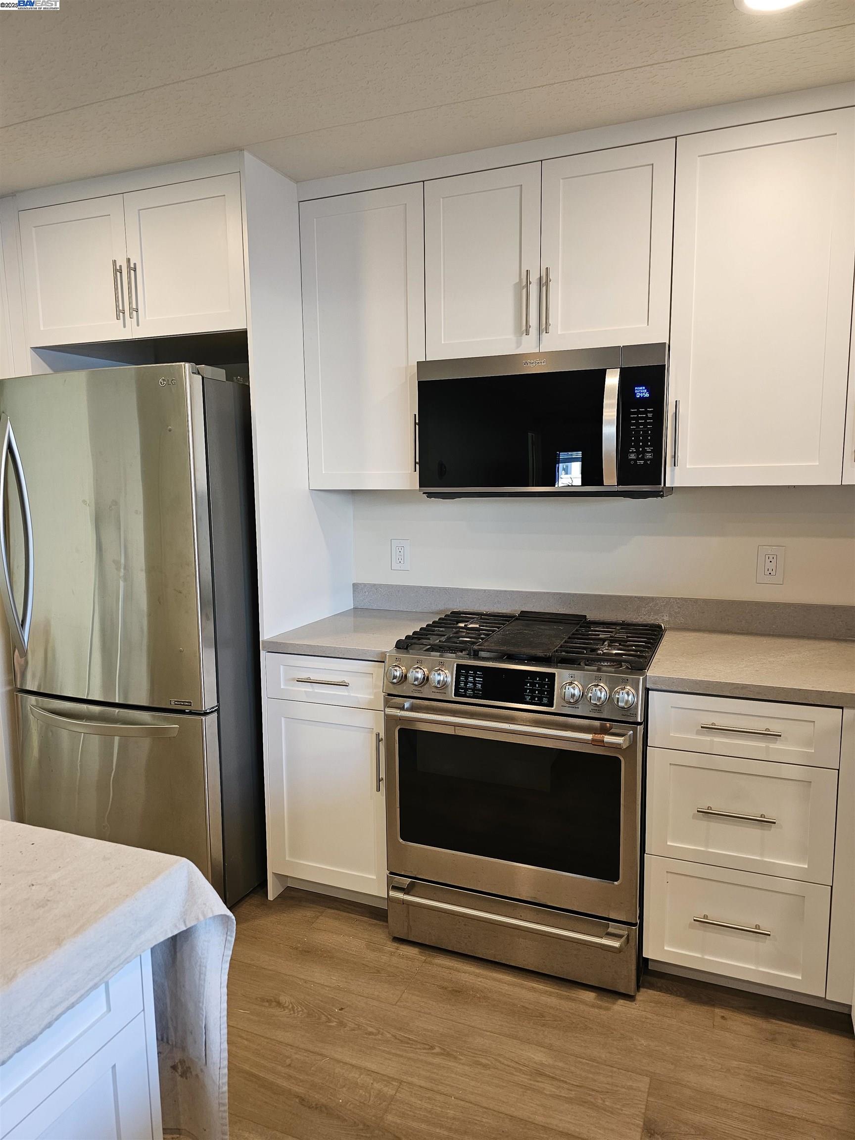 4141 Deep Creek Road, Unit 106 Fremont, CA 94555 - Photo 4 of 37 a kitchen with a stove and a refrigerator