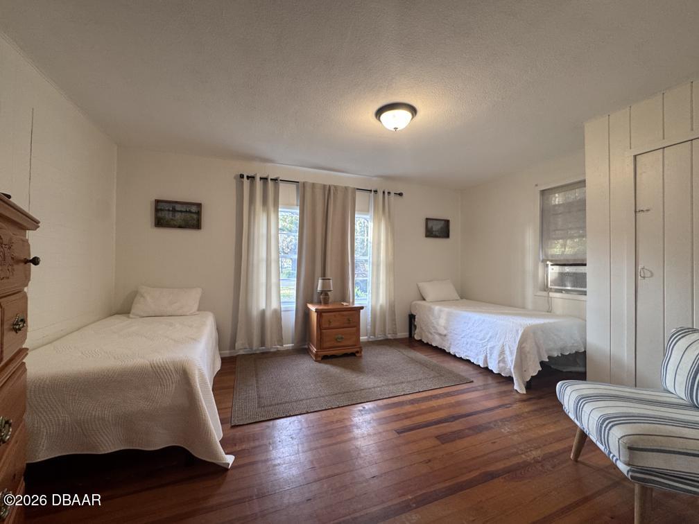 607 Herbert Street Port Orange, FL 32129 - Photo 13 of 26 a bedroom with a bed and wooden floor