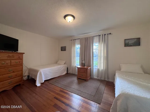 a bedroom with furniture and flat screen tv