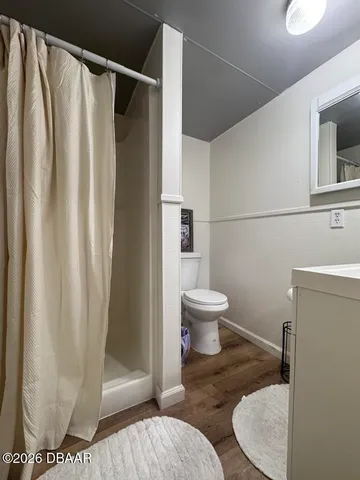 a bathroom with a toilet and a shower