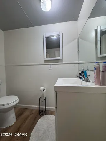 a bathroom with a sink a toilet and mirror