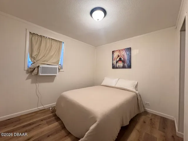 a bedroom with a bed and a painting on the wall