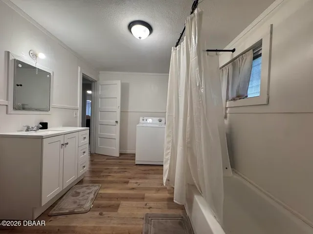 a bathroom with a sink a mirror and a shower