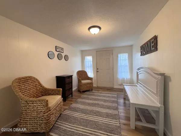 a bedroom with furniture and wooden floor